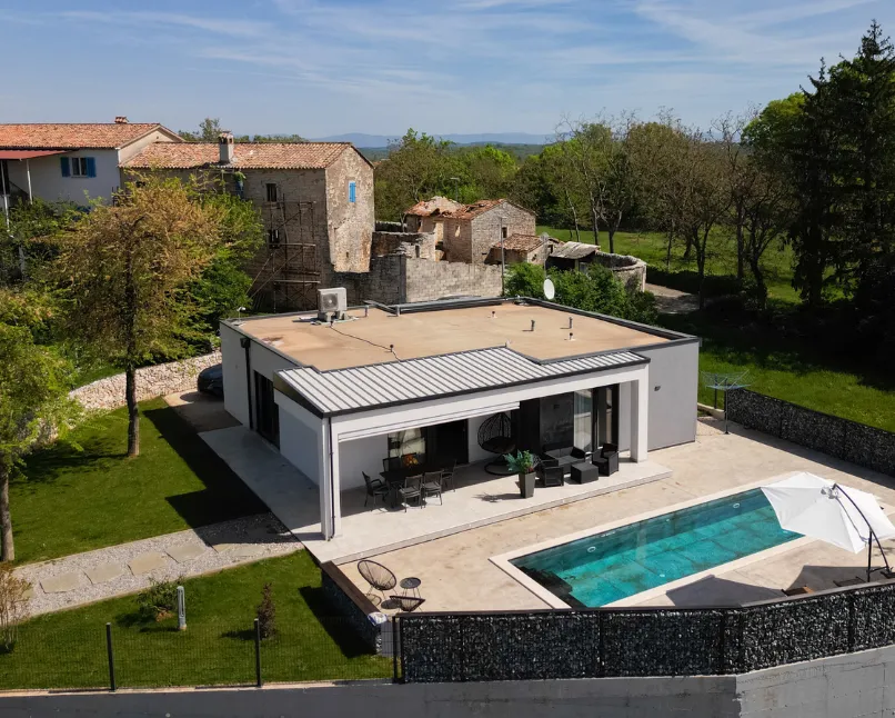 Modern prefabricated ADU installed in Los Angeles backyard featuring contemporary design, patio area, and swimming pool